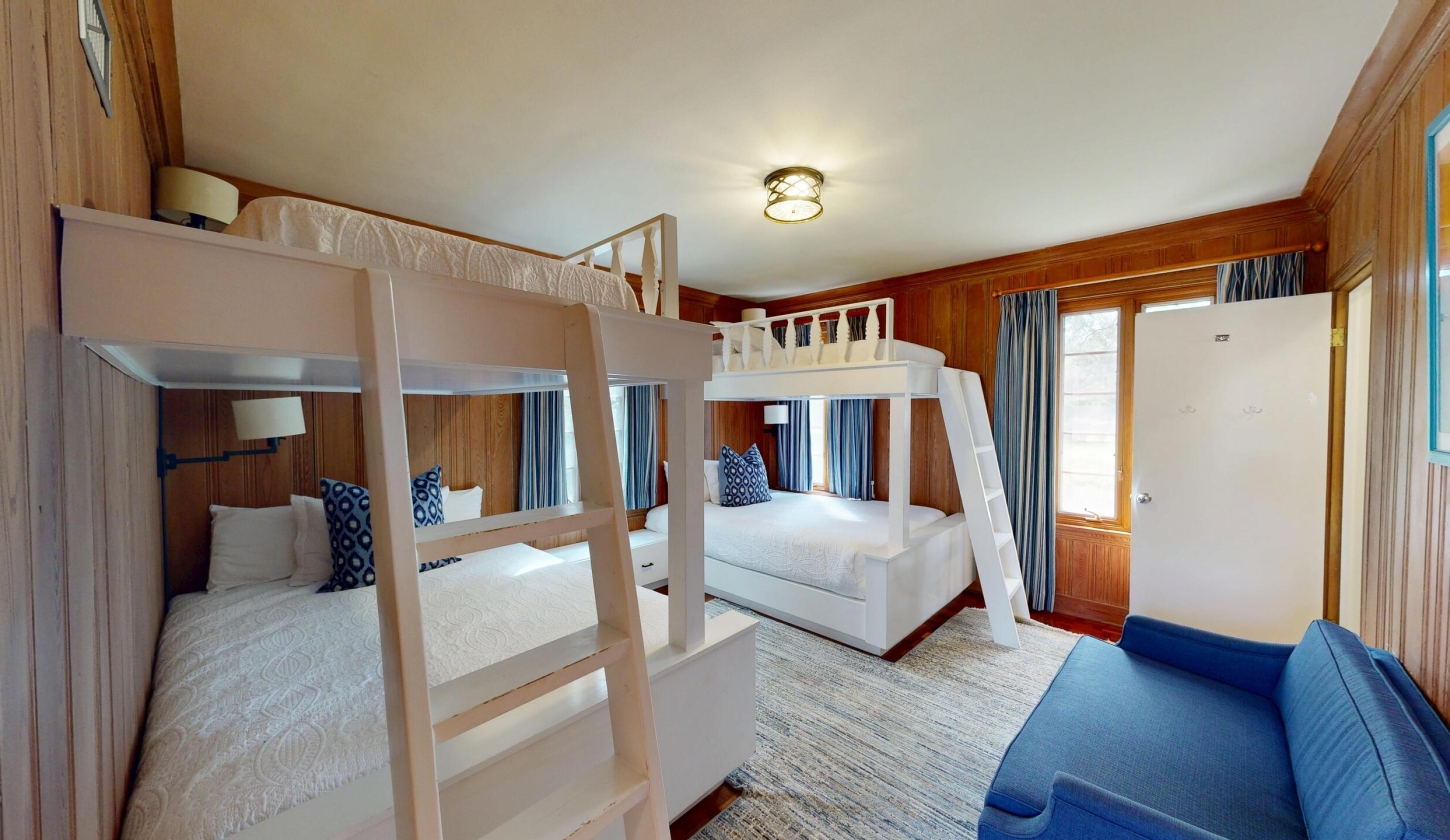 A cosy room with two sets of bunk beds
