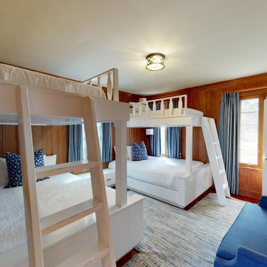 A cosy room with two sets of bunk beds
