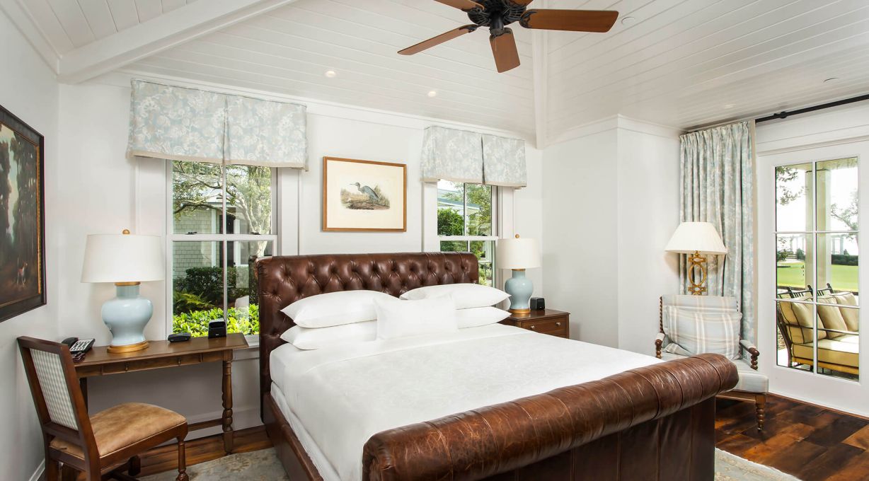 A Sea Island Cottage king bed with walkout sunroom