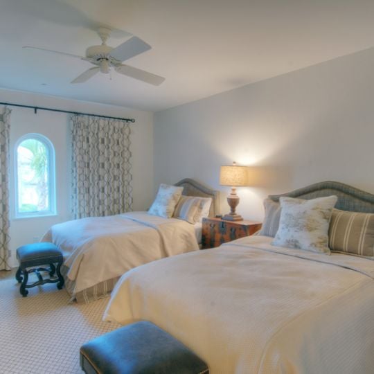 Bedroom with two queen beds and dark teal undertones