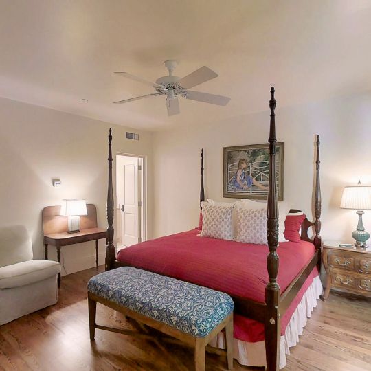 bedroom with queen bed and bench