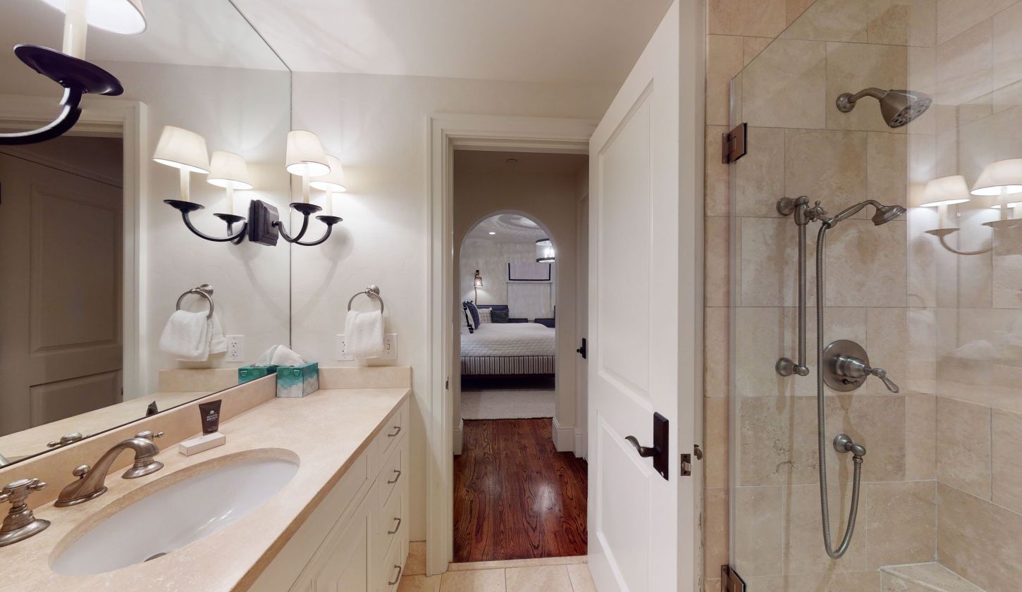 bathroom with walk-in shower and long vanity