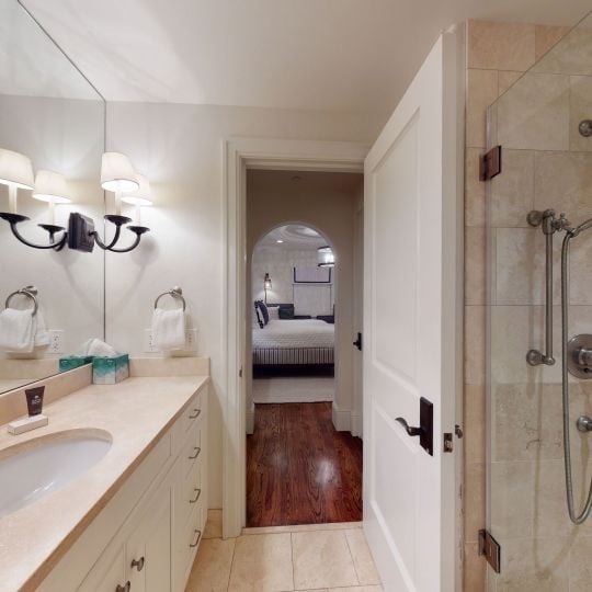 bathroom with walk-in shower and long vanity