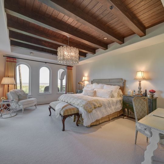 Bedroom with desk and plenty of windows
