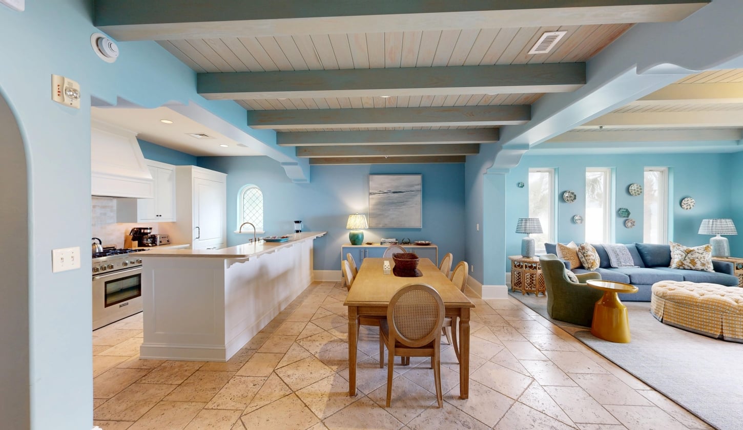 A kitchen and dining room with wood-vaulted ceilings