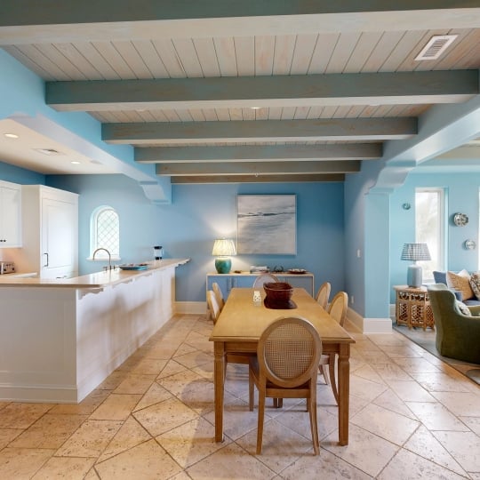 A kitchen and dining room with wood-vaulted ceilings