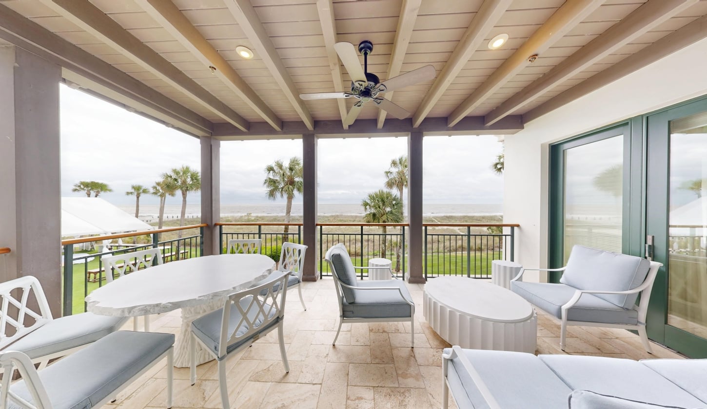 A patio overlooking palm trees and the Atlantic ocean