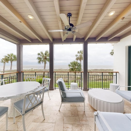 A patio overlooking palm trees and the Atlantic ocean