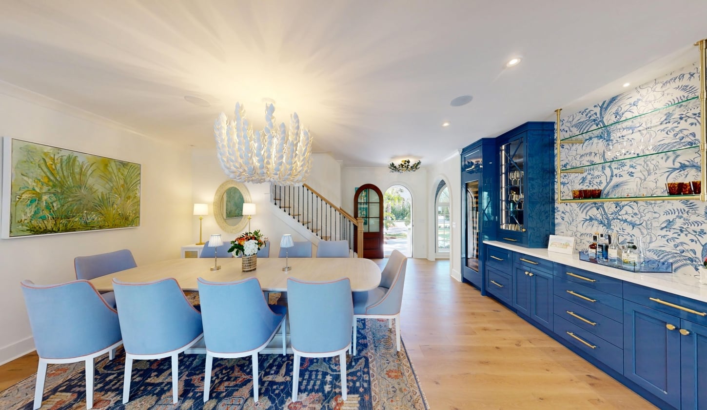 A dining table beside blue cabinetry