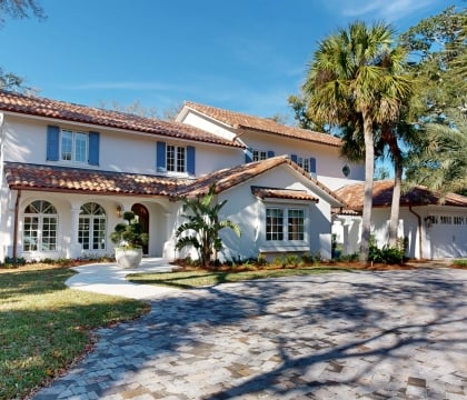 The front view of a large white cottage