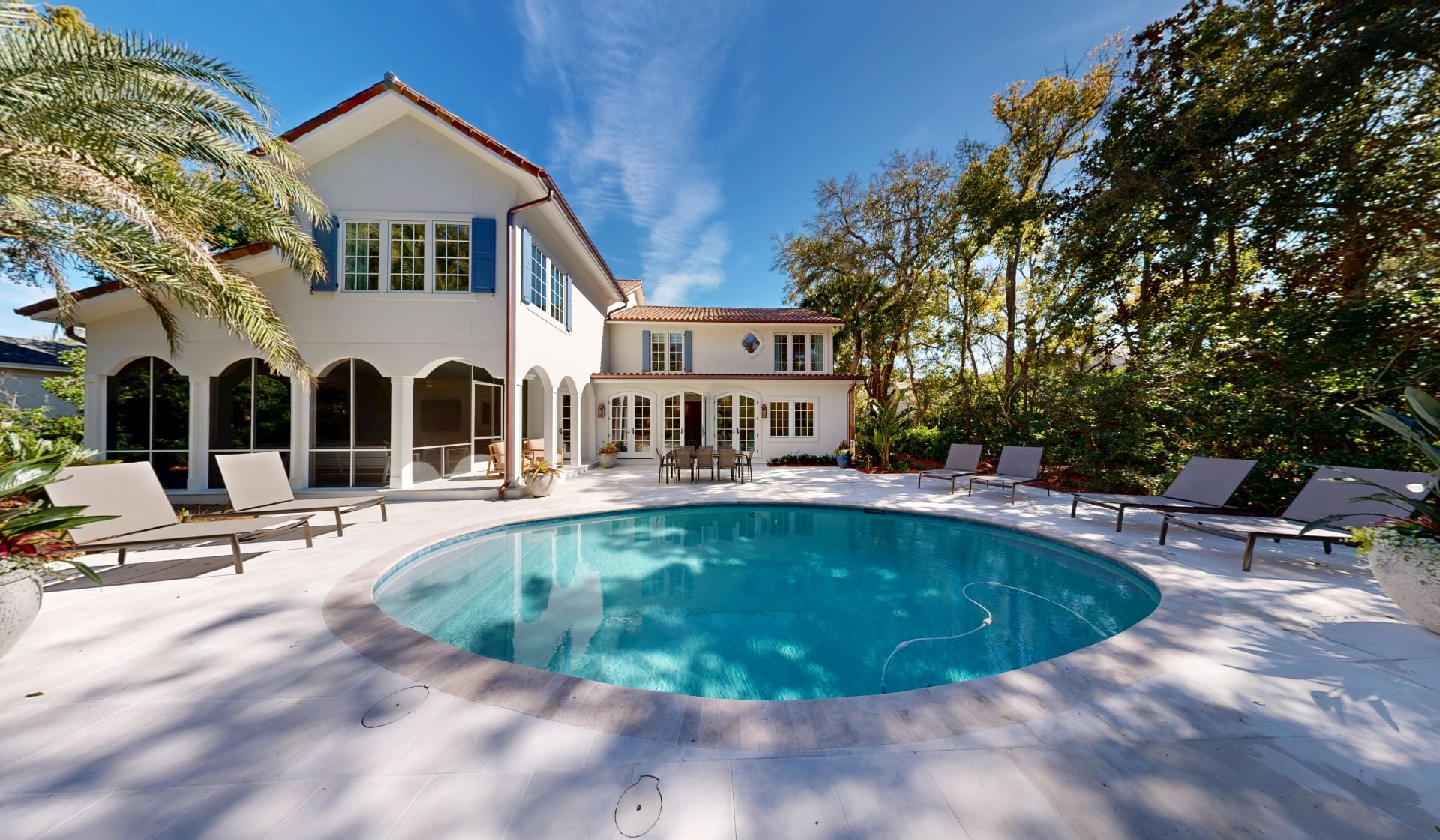 A private circular pool in the backyard of a large cottage