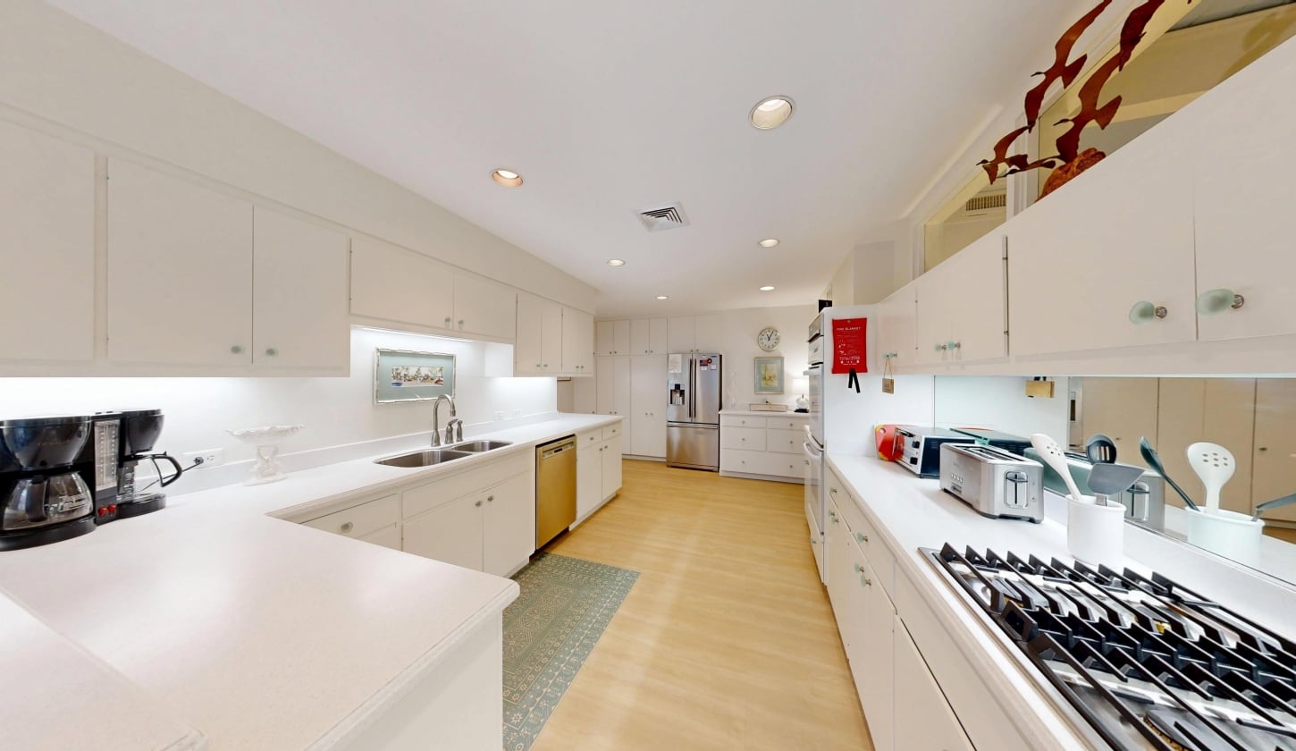 A spacious kitchen with white cabinetry