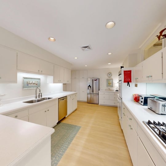 A spacious kitchen with white cabinetry
