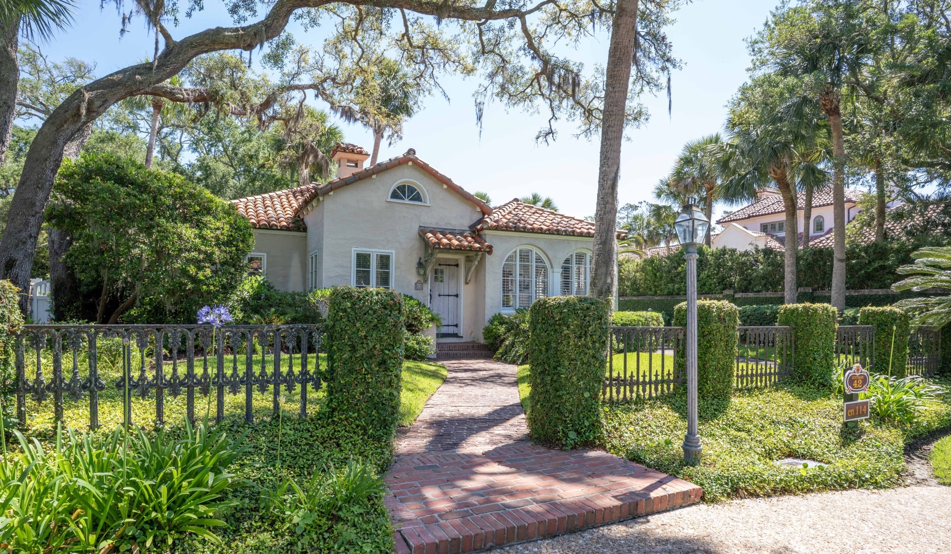 A fenced in property with Spanish architecture