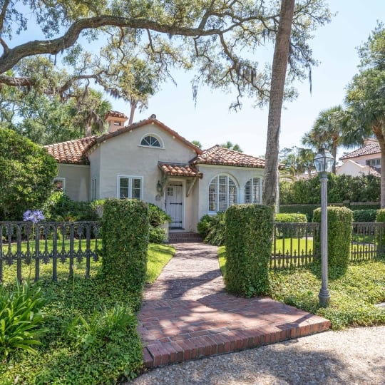 A fenced in property with Spanish architecture