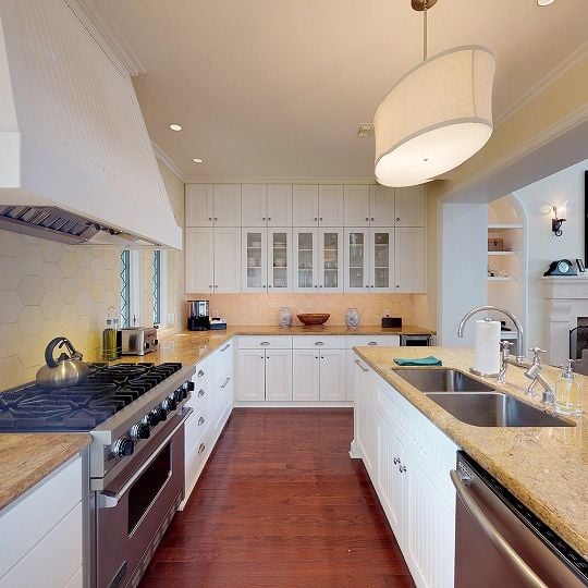 Kitchen with white cabinets and light tan countertops