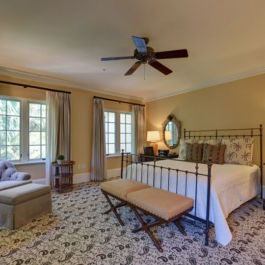 Bedroom with queen bed and chair