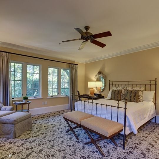 Bedroom with a queen bed and chair