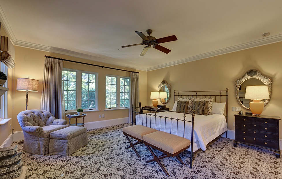 Bedroom with a queen bed and chair