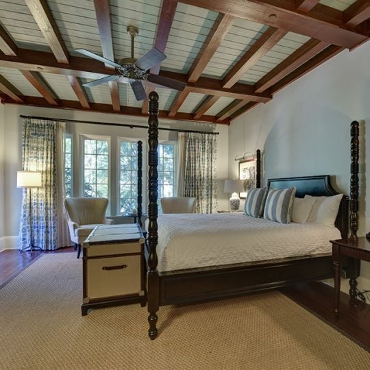 Bedroom with large bed and trunk