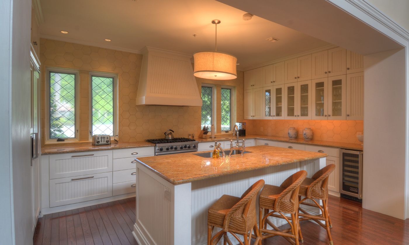 Kitchen with white cabinets and orange countertops