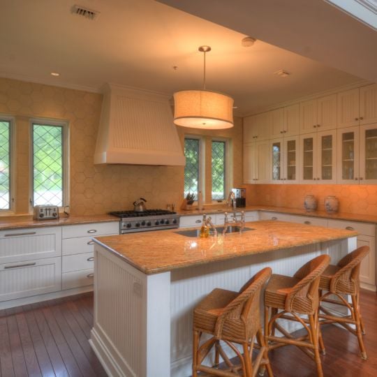 Kitchen with white cabinets and orange countertops