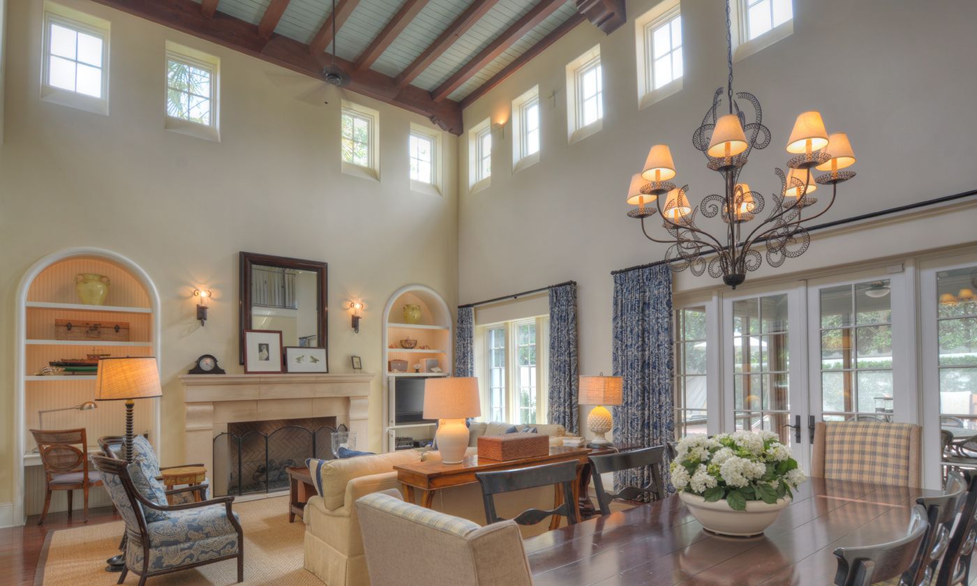 Living room and dining room with high exposed wood ceilings