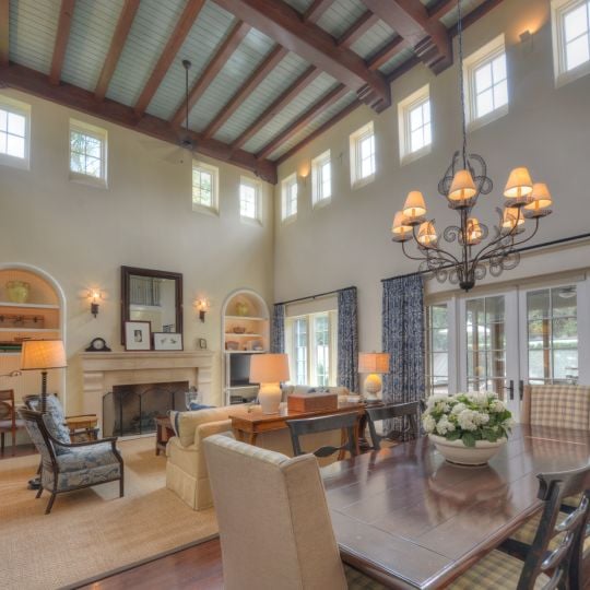 Living room and dining room with high exposed wood ceilings