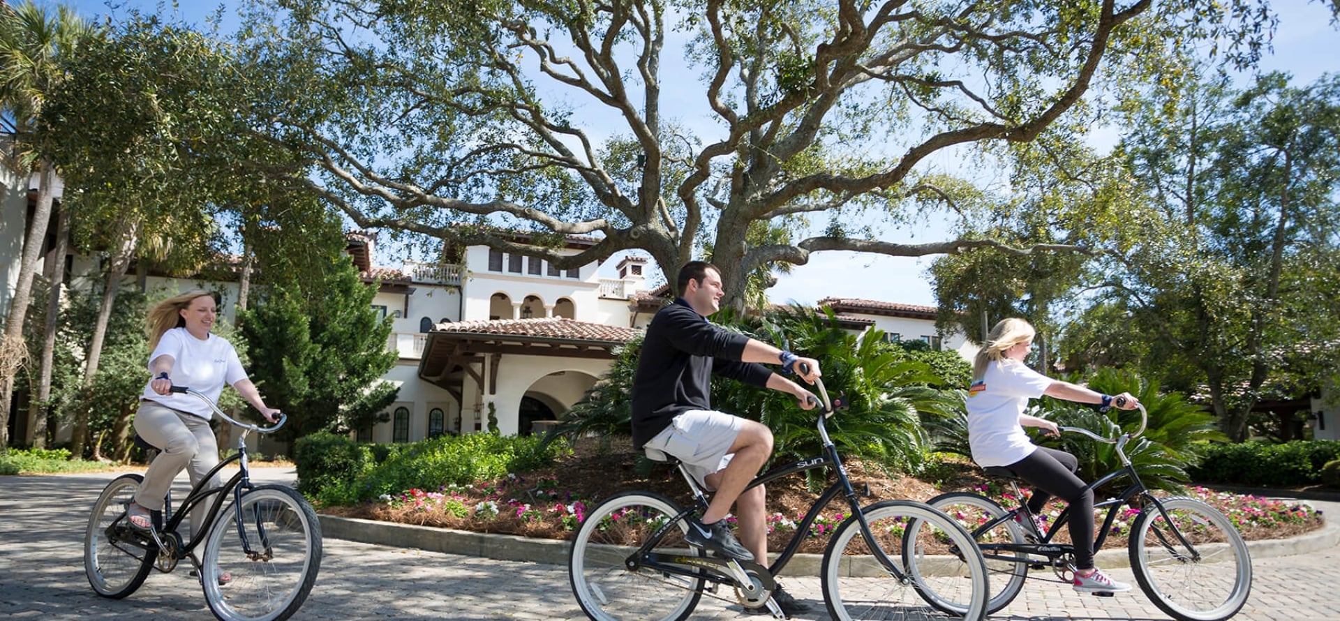 people biking in front of the cloister