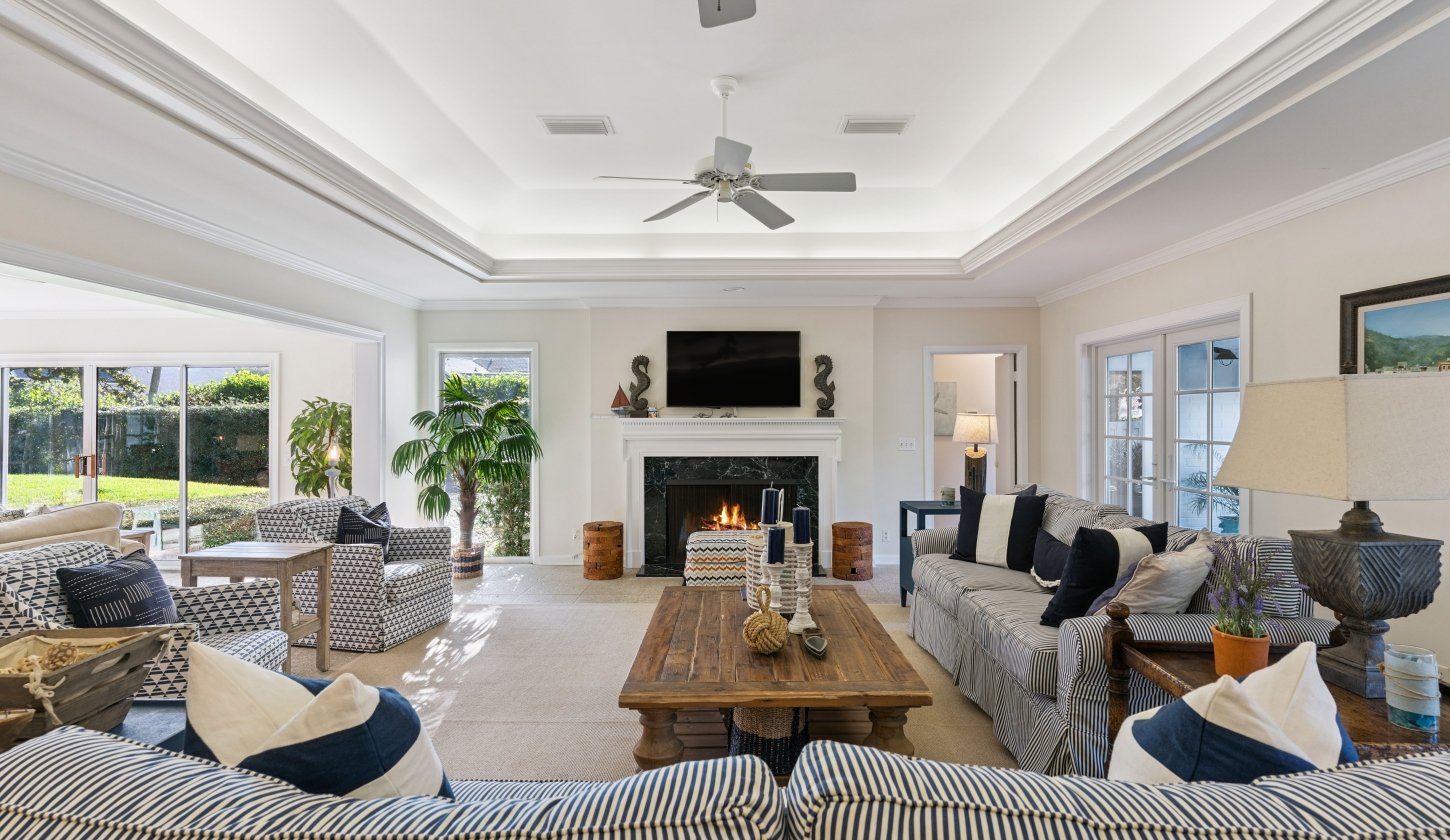 A spacious living room with seating around a fireplace