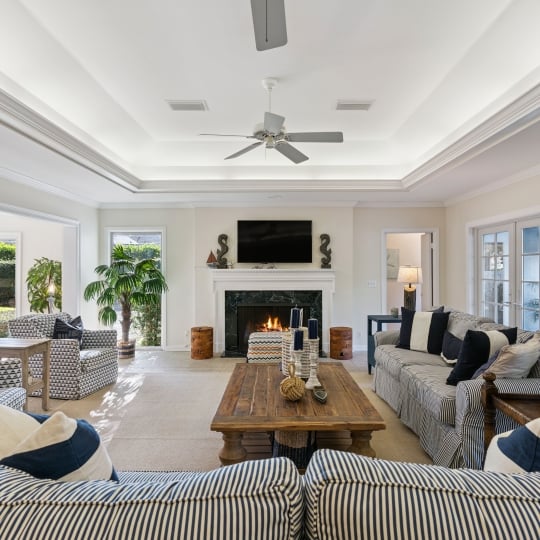 A spacious living room with seating around a fireplace