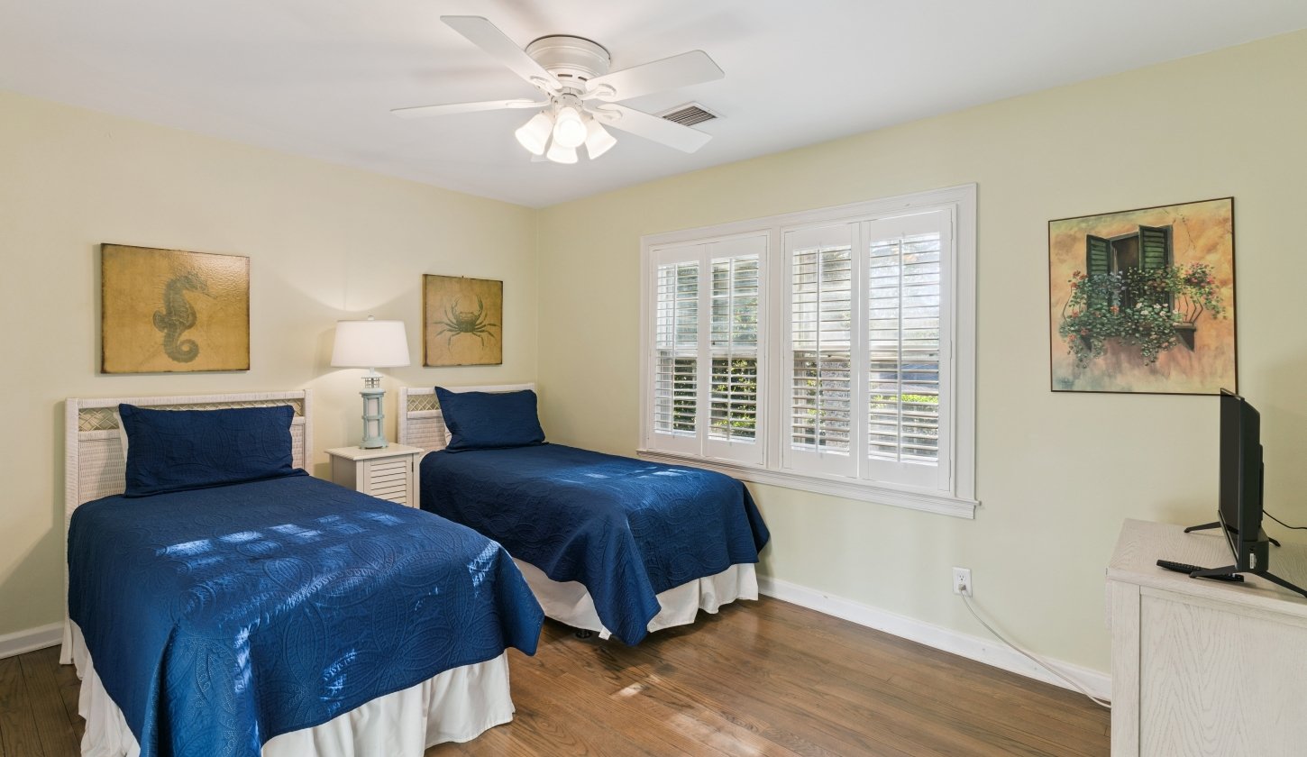 Two twin beds and a large window with a beautiful view