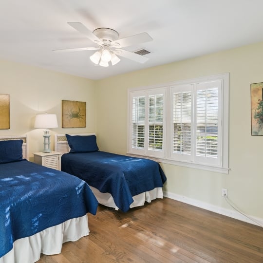 Two twin beds and a large window with a beautiful view