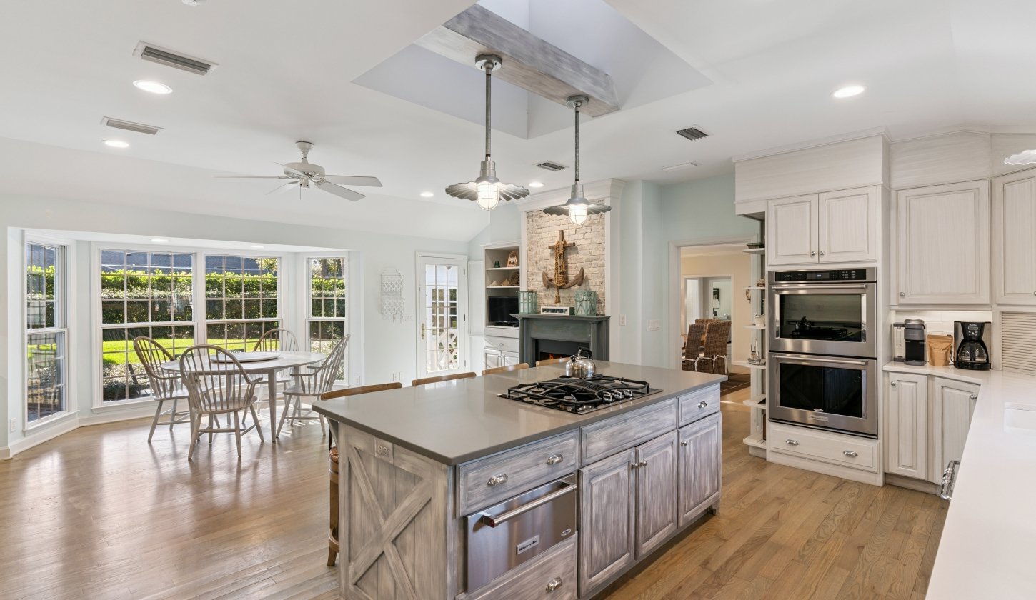 A luxurious kitchen island connecting to a dining area