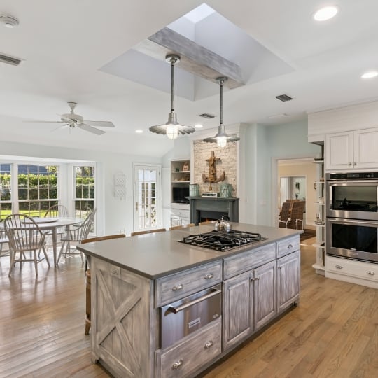 A luxurious kitchen island connecting to a dining area