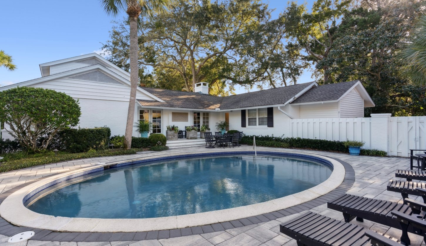 Circular pool with lounge chairs nearby