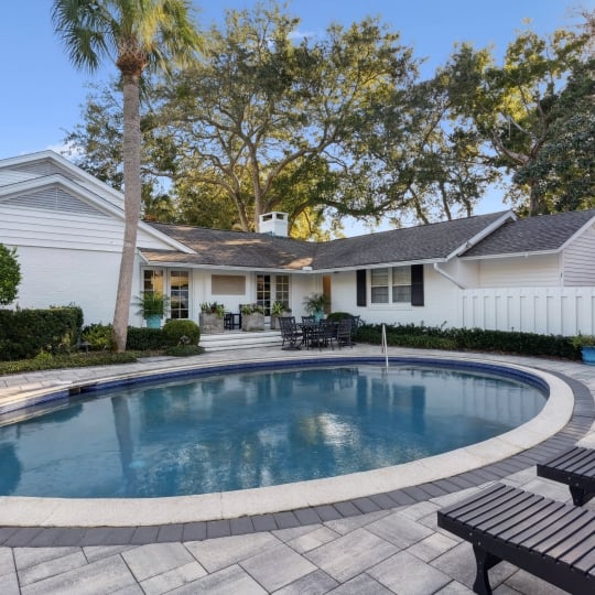 Circular pool with lounge chairs nearby