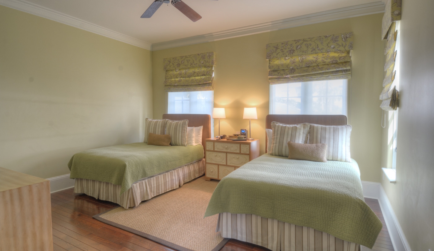 Green bedroom with two twin beds