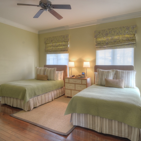 Green bedroom with two twin beds