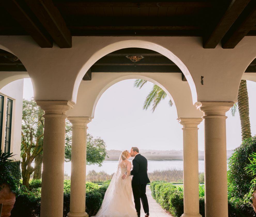bride and groom under an archway