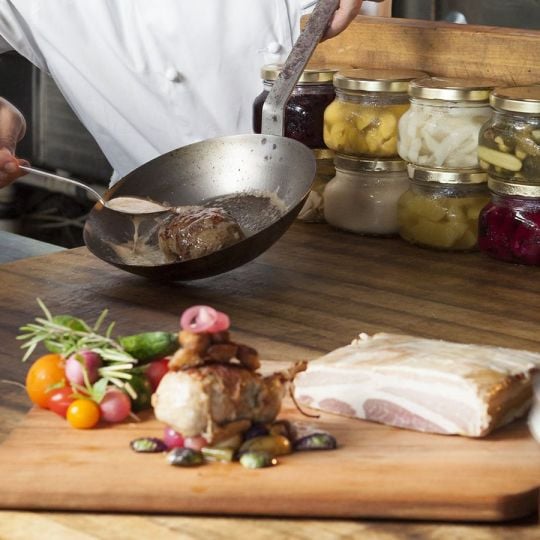 A chef at Sea Island preparing a meal