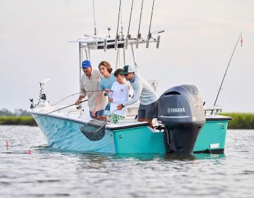 Men and boys fishing on boat