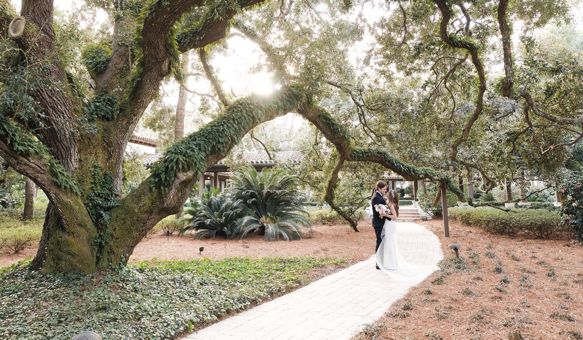 bride and Groom kissing on pathway