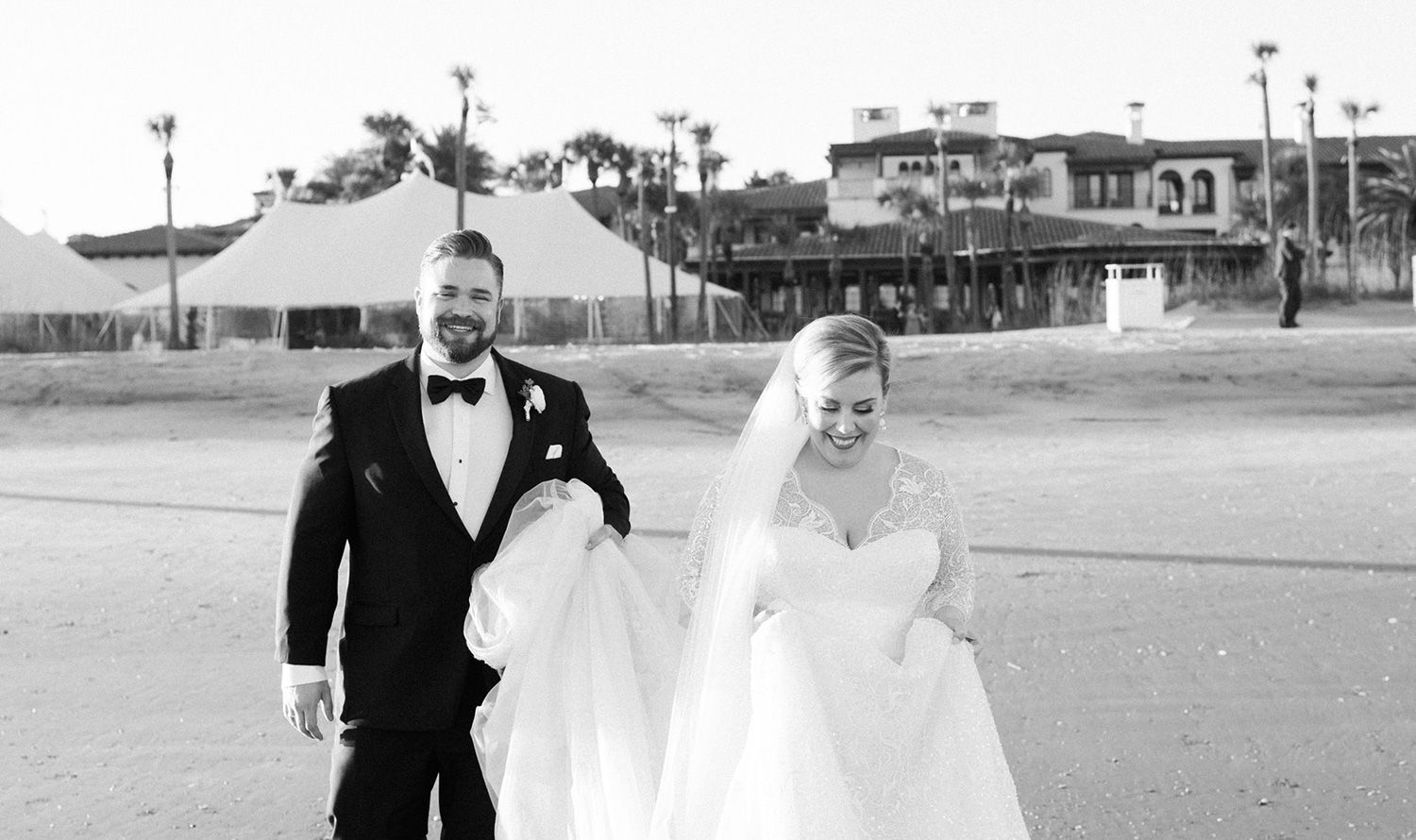 bride and groom walking on the beach