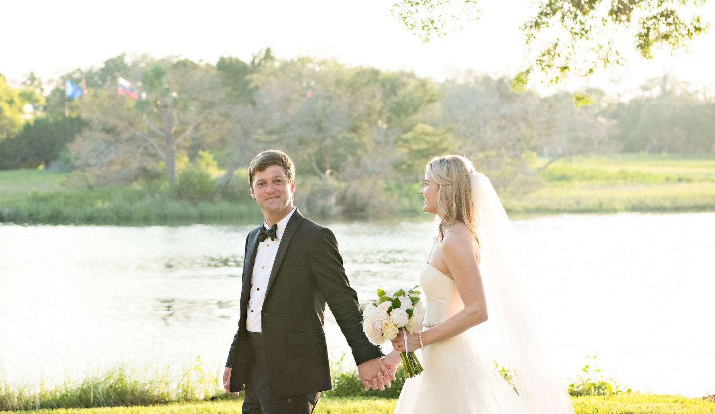 bride and groom holding hands