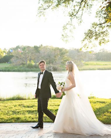 bride and groom holding hands