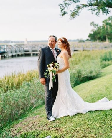 a bride and groom pose for a photo