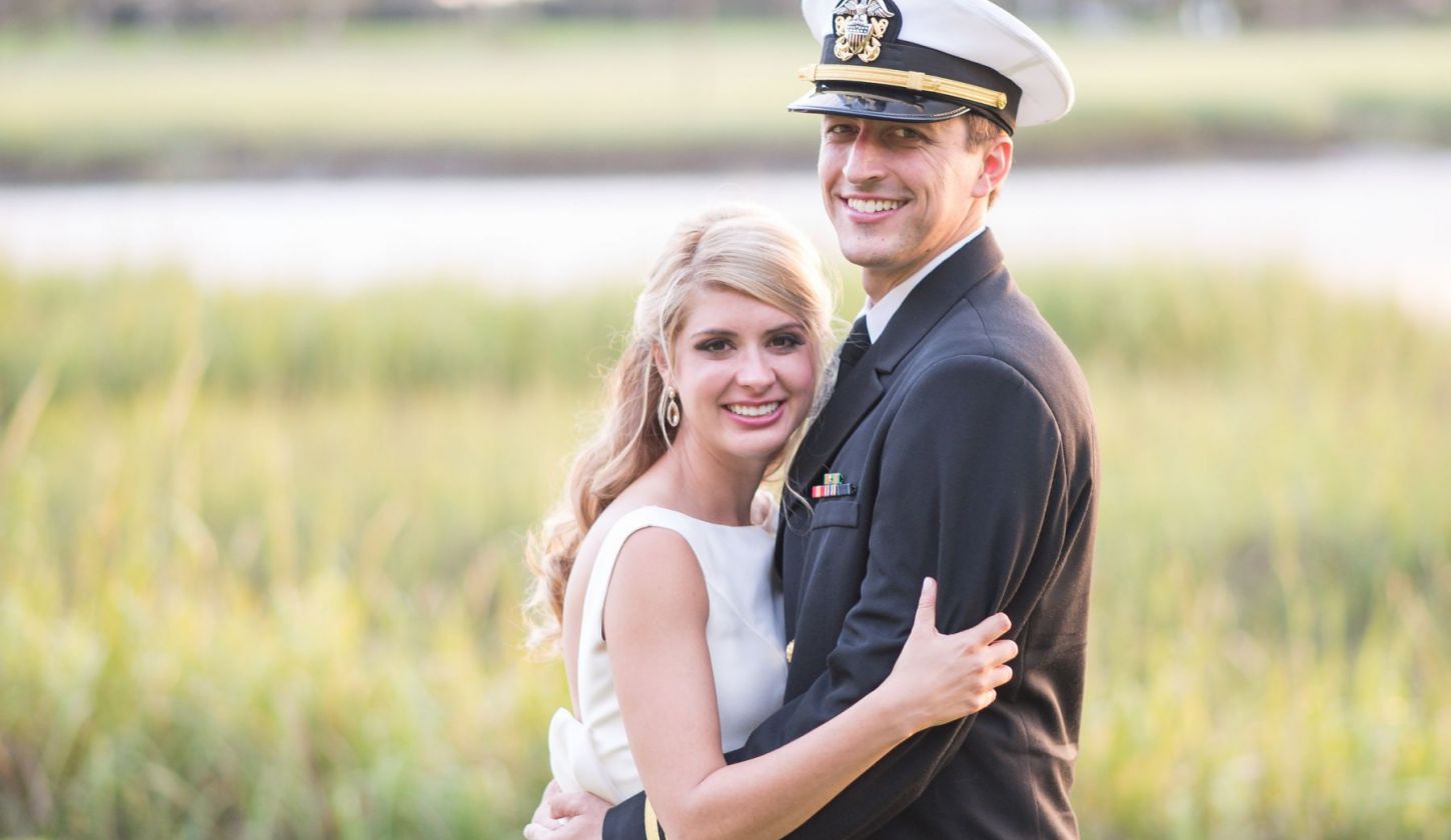 a bride and groom pose for a photo