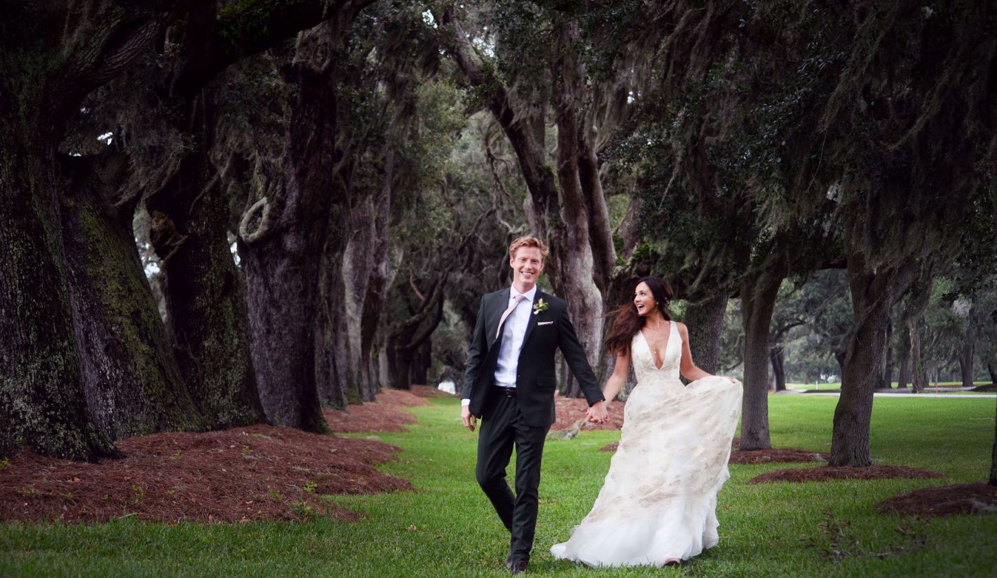 a bride and groom walking outdoors at Sea Island