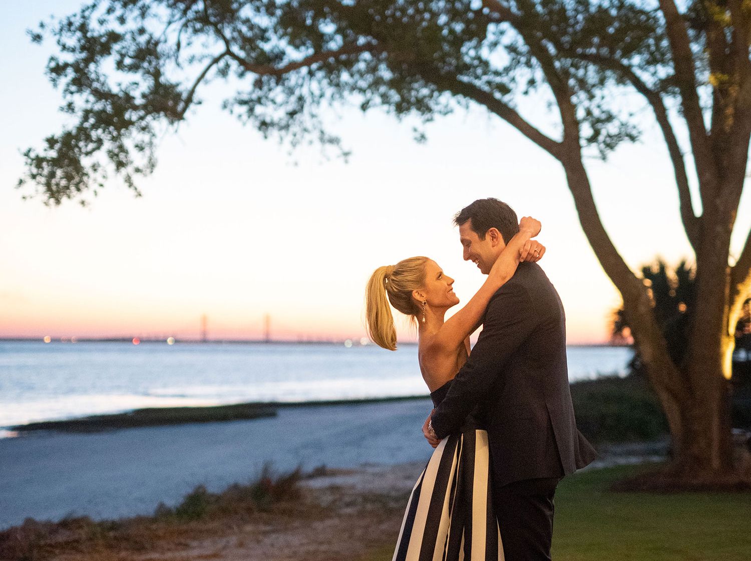 a bride and groom embrace on the lawn at Sea Island